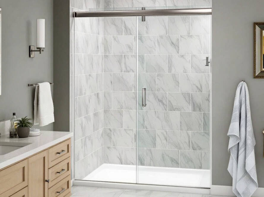 A newly installed, chic frameless shower door enhancing the modern and contemporary ambiance of a bathroom in Revere, MA.