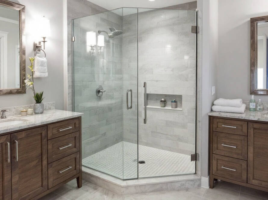 A person skillfully installing a sleek, modern hinged shower door.