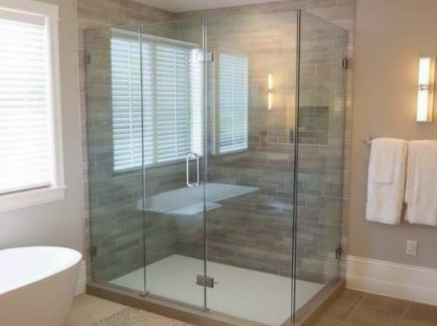 A picture displaying a newly installed custom frameless modern shower enclosure in a contemporary designed bathroom near Natick, MA.