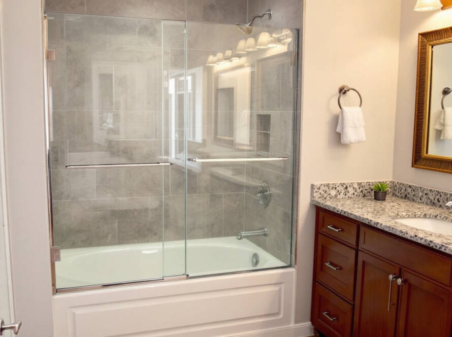 A newly installed modern bathtub shower door in Boston, embodying a contemporary design.