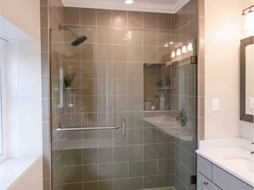 An elegant shower door installed in a Hingham residence showcasing modern, contemporary design principles.