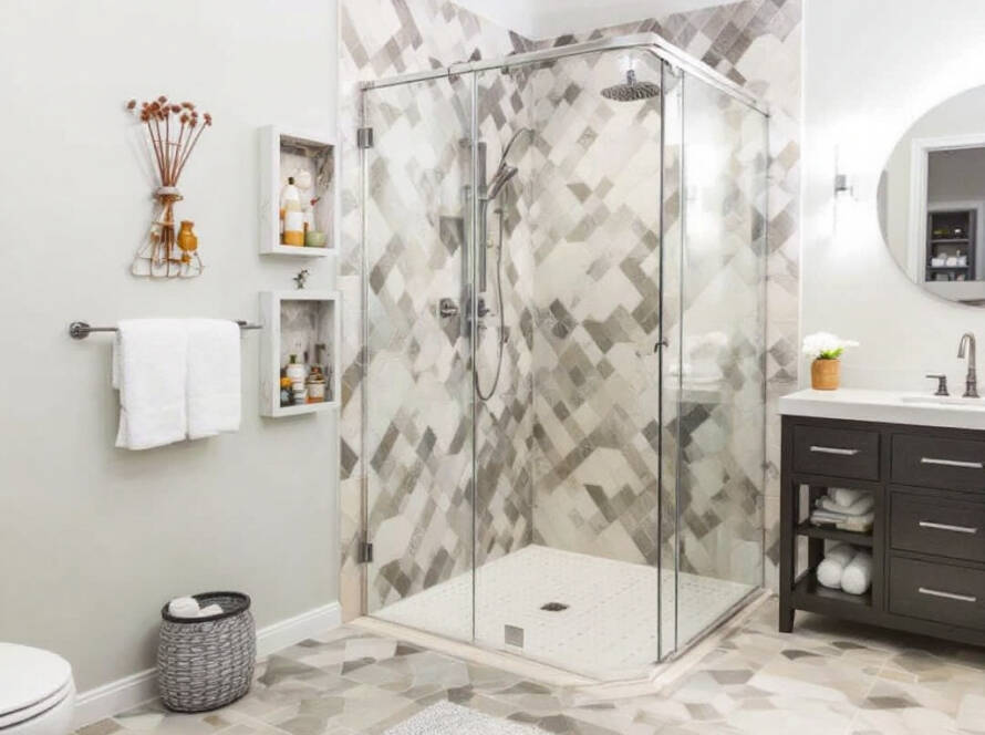 A modern and elegant shower enclosure being installed in a contemporary style bathroom in Waltham MA.