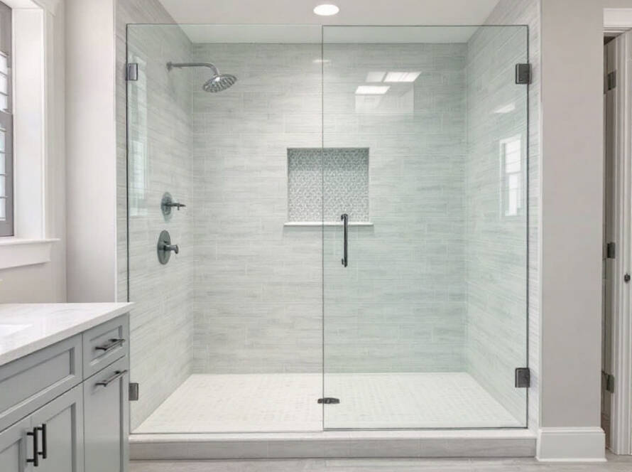 Alt Text: A modern custom frameless shower enclosure with contemporary design elements in a freshly renovated Wayland, MA home.