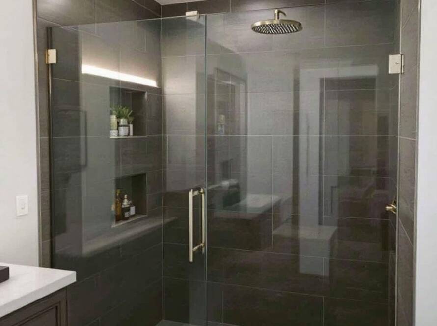 A photo showcasing the remarkable craftsmanship and modern, contemporary design of Ideal Shower Doors' custom glass installation.