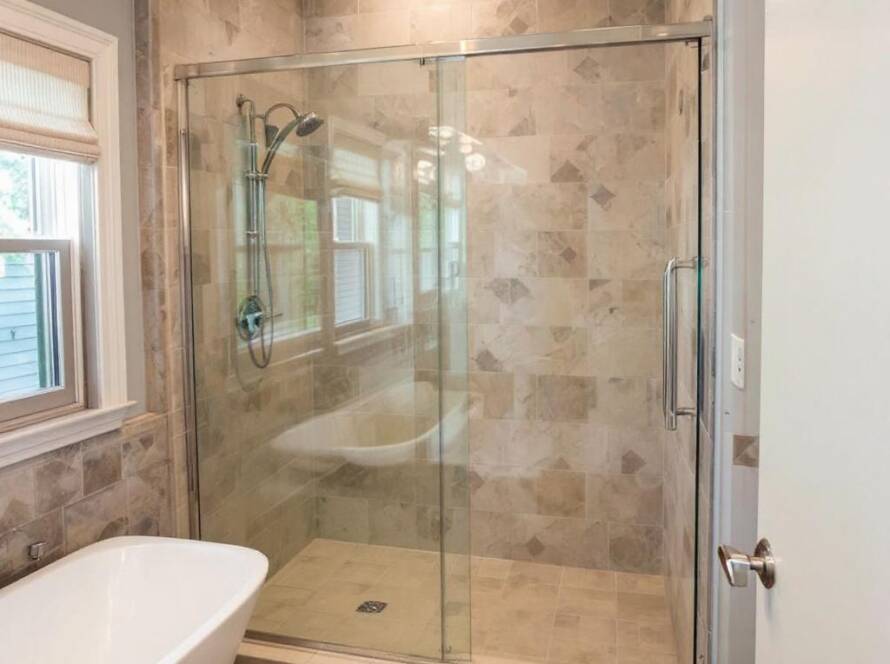 Alt text: Professional installation of a sliding shower door with contemporary design in Wakefield, MA.