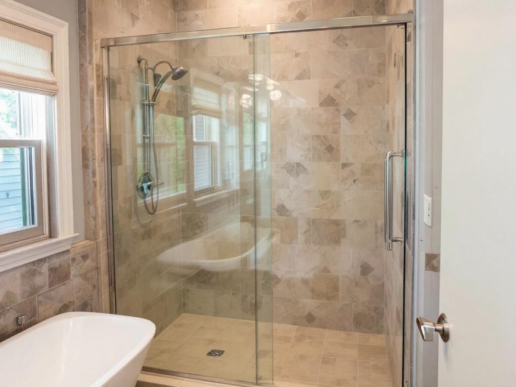 Alt text: Professional installation of a sliding shower door with contemporary design in Wakefield, MA.