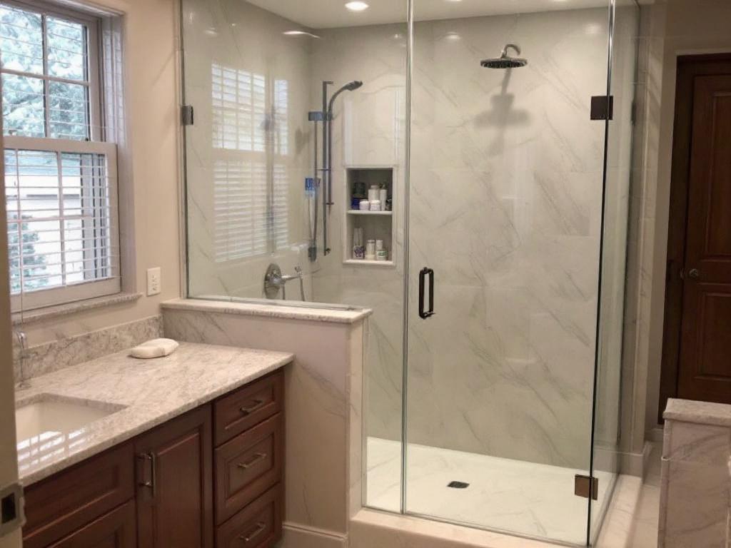 Alt Text: Luxury, custom frameless shower enclosure installed in a modern styled bathroom near Waltham, MA.