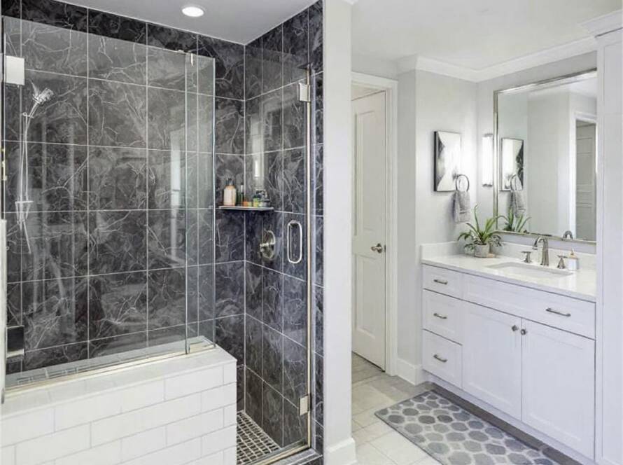 Professional shower door installers from Burlington standing with their newly crafted modern and contemporary glass shower door design.