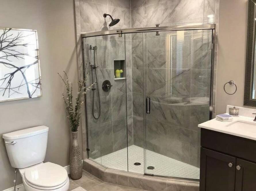 Image displaying the transformation of a bathroom updated with a new modern shower door installation near Bedford, MA by professional installers.
