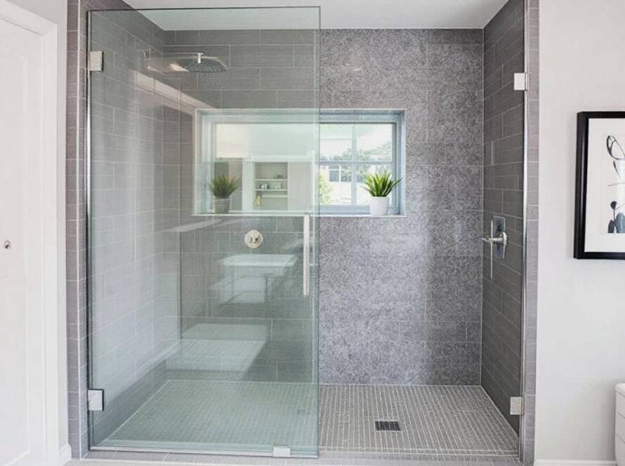 An elegant display of a modern shower glass installation in a contemporary bathroom style in Maynard MA.