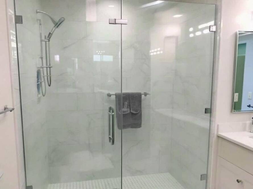 Frameless glass shower installation showcasing modern design in a Saugus, MA bathroom.