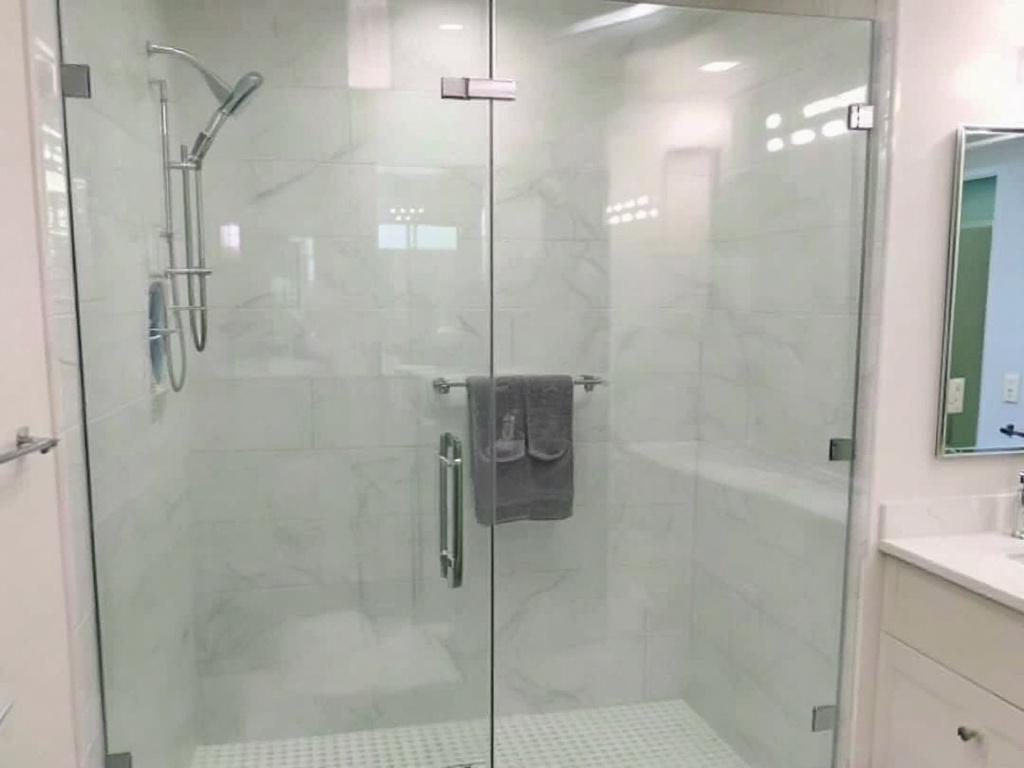 Frameless glass shower installation showcasing modern design in a Saugus, MA bathroom. 