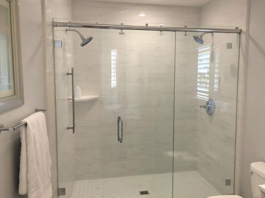 Professional installation of a frameless shower door providing a sleek modern feel to a bathroom near Somerville, MA.