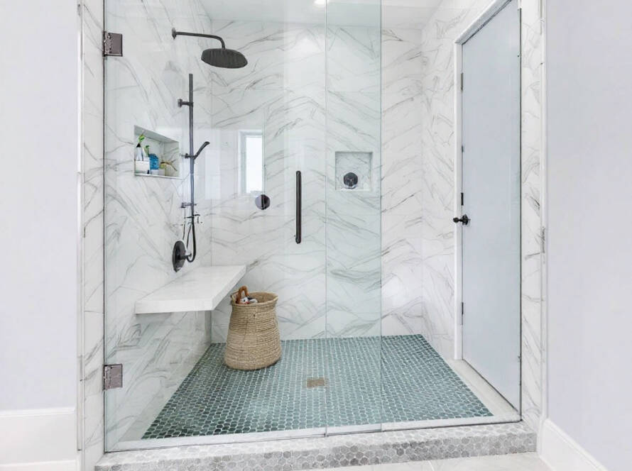 A stylish and contemporary custom frameless shower glass designed by the Premier Shower Glass Company in a modern bathroom.