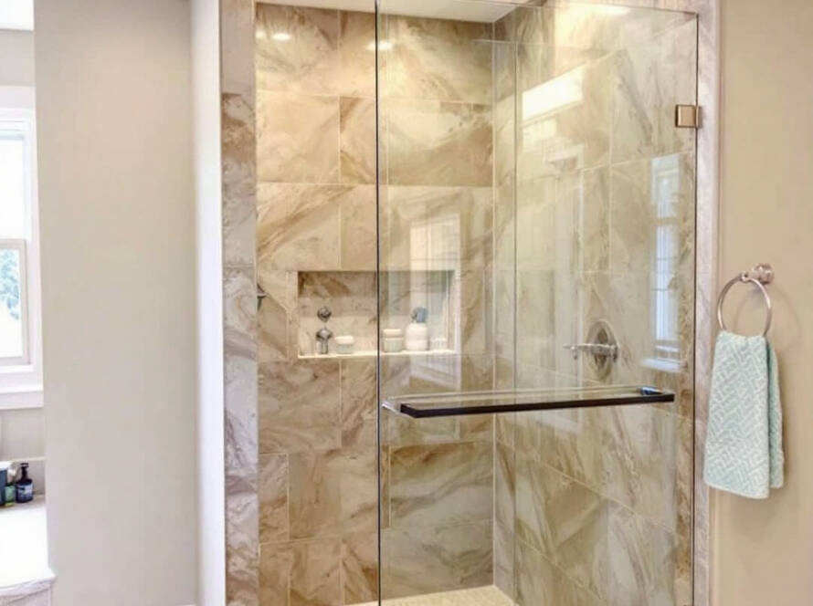 A professional installing a sleek, contemporary sliding shower door as part of a new modern bathroom update.