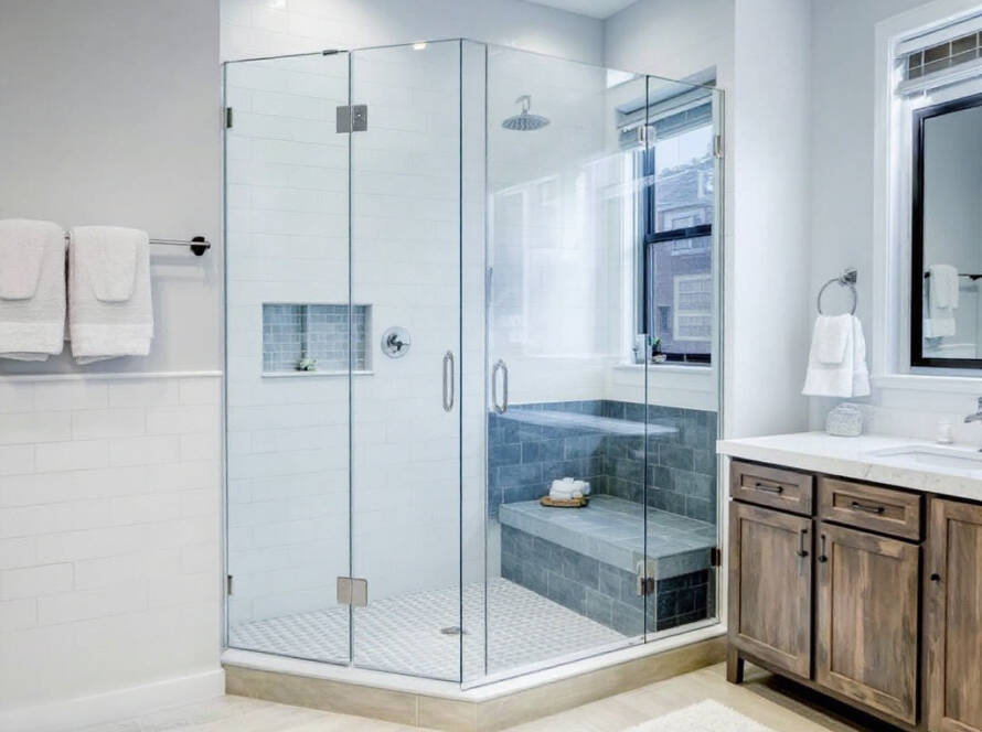 A modern, contemporary-designed frameless shower door installed in a bathroom near Boston, MA.